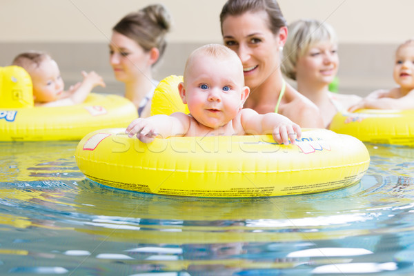 Mothers and kids having fun together playing with toys in pool Stock photo © Kzenon