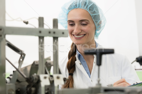 Portrait of happy woman technician checking industrial equipment Stock photo © Kzenon