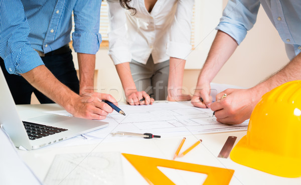 Stock photo: Discussion of construction plans in architects office