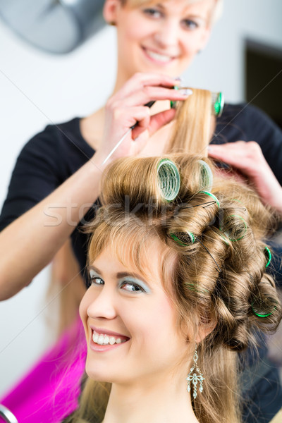 Women at the hairdresser being curled Stock photo © Kzenon