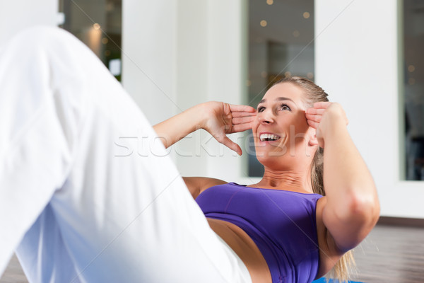 Woman doing sit ups in gym Stock photo © Kzenon