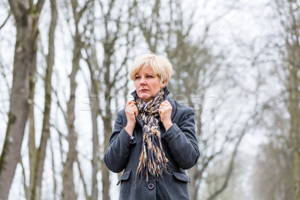 Depressed or sad woman walking in winter Stock photo © Kzenon