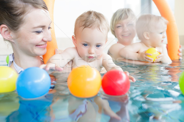 Mums and babies having fun at infant swimming course  Stock photo © Kzenon