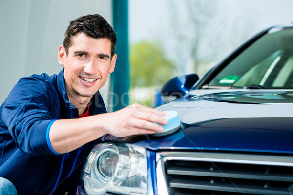 Man using an absorbent towel for drying the surface of a car Stock photo © Kzenon