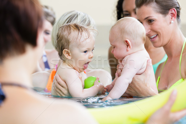 Mothers being happy about their babies playing with each other Stock photo © Kzenon