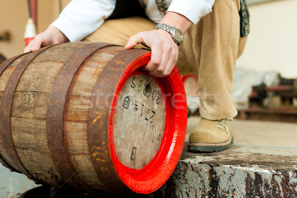 Stock photo: Brewer with beer barrel in brewery