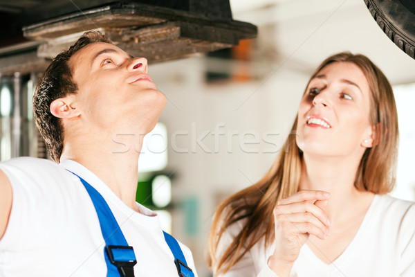 Woman talking to car mechanic in repair shop Stock photo © Kzenon