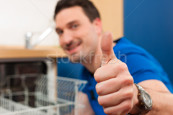 Technician repairing the dishwasher Stock photo © Kzenon