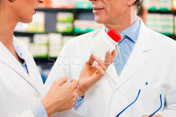 Stock photo: Two pharmacists in pharmacy consulting