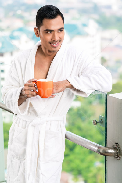 Asian man in morning front of city skyline Stock photo © Kzenon