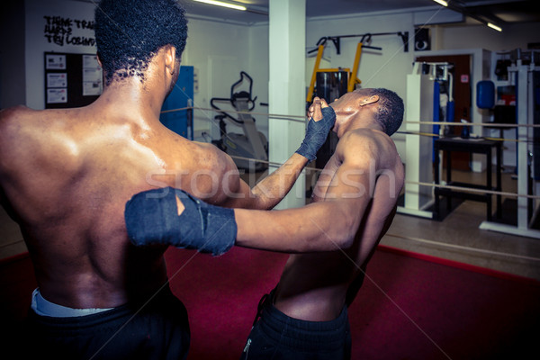 Two African American fighters practicing MMA takedown techniques Stock photo © Kzenon