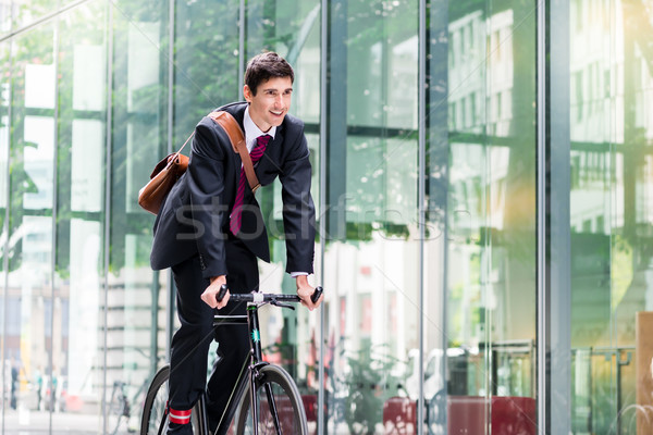 Cheerful young employee riding an utility bicycle in Berlin Stock photo © Kzenon
