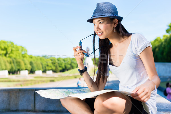 Asian female tourist holding a map outdoors Stock photo © Kzenon