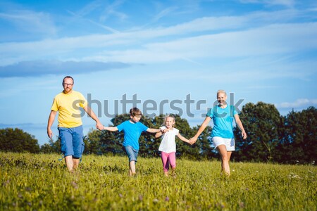 Family playing, running and doing sport in summer Stock photo © Kzenon