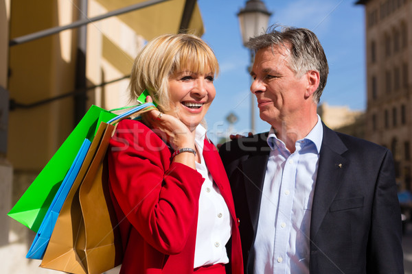 Senior couple strolling through the city in spring shopping Stock photo © Kzenon