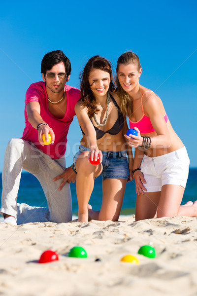 Man and women playing boule on beach Stock photo © Kzenon