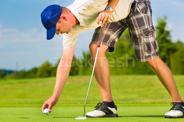 Young golf player on course putting Stock photo © Kzenon
