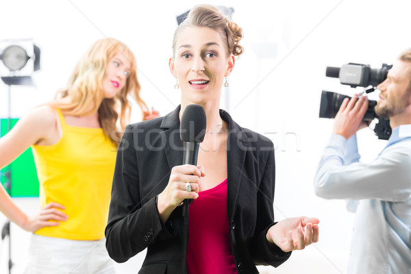 Reporter moderating an interview on film set Stock photo © Kzenon