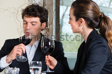 Couple drinking red wine clinking glasses Stock photo © Kzenon