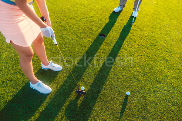 woman player ready to hit the ball into the hole at the end of a Stock photo © Kzenon