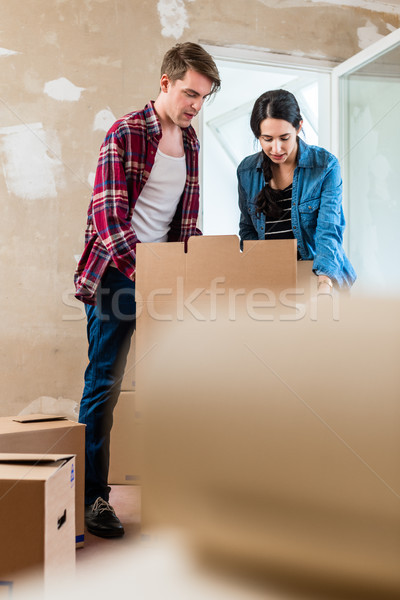 Young woman bringing open box moving in with her boyfriend into  Stock photo © Kzenon