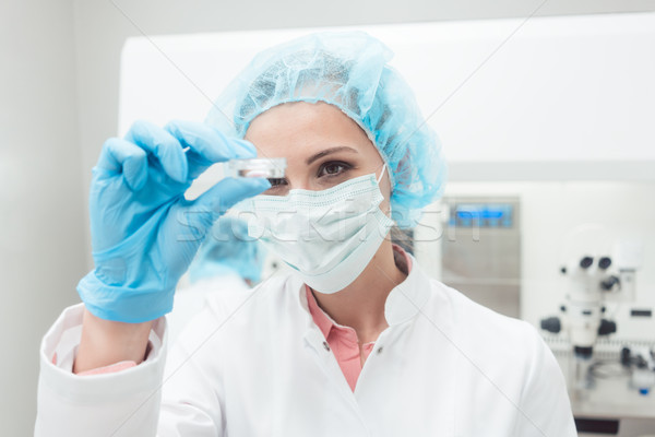 Woman scientist showing her newest biotech experiment in lab Stock photo © Kzenon