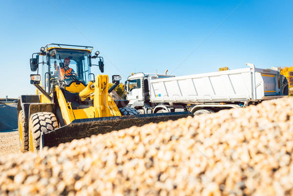 Construction workers doing earthworks with wheel loader Stock photo © Kzenon