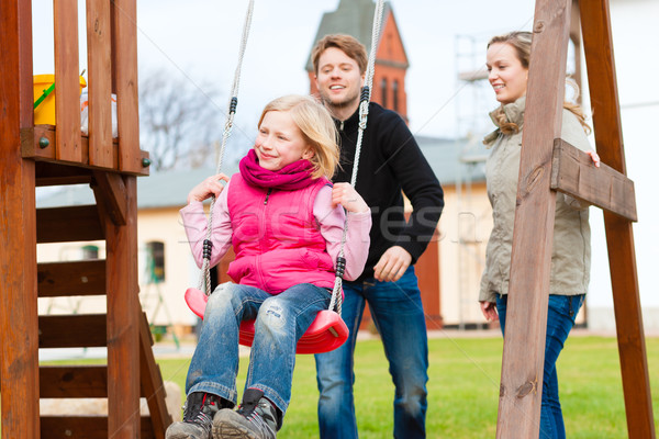 Family on the playground Stock photo © Kzenon