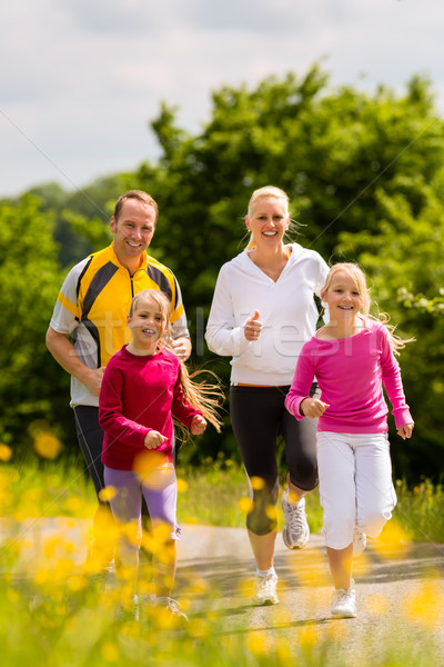 Family jogging for sport outdoors with the kids on summer day Stock photo © Kzenon