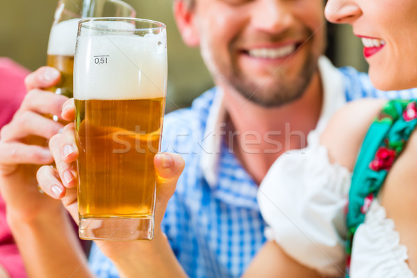 Young people in Bavarian Tracht in restaurant or pub Stock photo © Kzenon