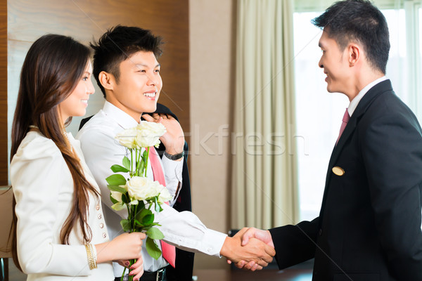 Asian Chinese hotel manager welcome VIP guests Stock photo © Kzenon