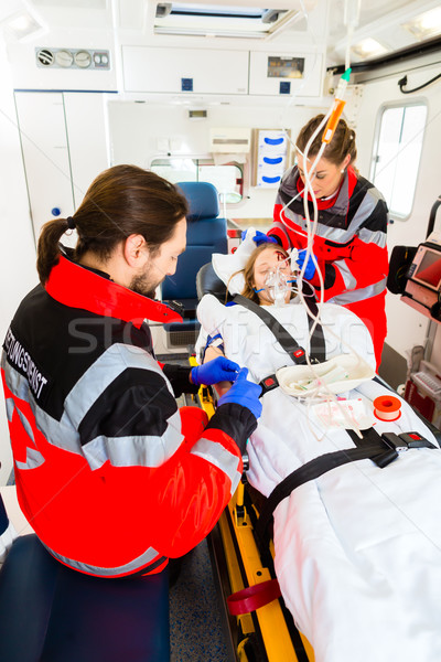 Ambulance helping injured woman with infusion Stock photo © Kzenon