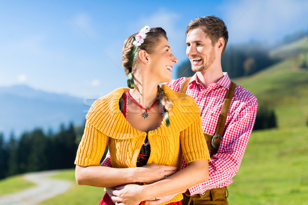 Couple in Tracht on Alp mountain summit at vacation Stock photo © Kzenon