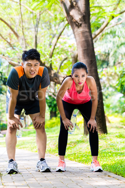 Asian couple take breathless break from running  Stock photo © Kzenon
