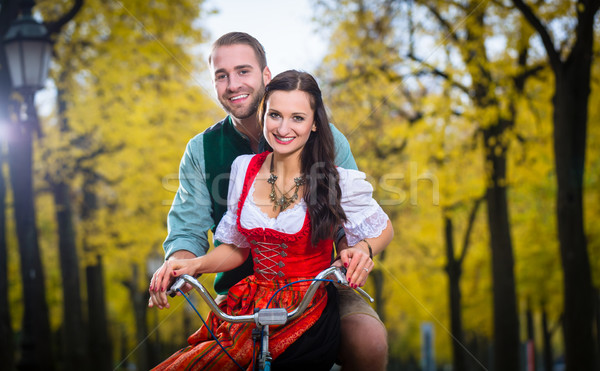 Couple in Dirndl and Leather trousers together on a bike Stock photo © Kzenon