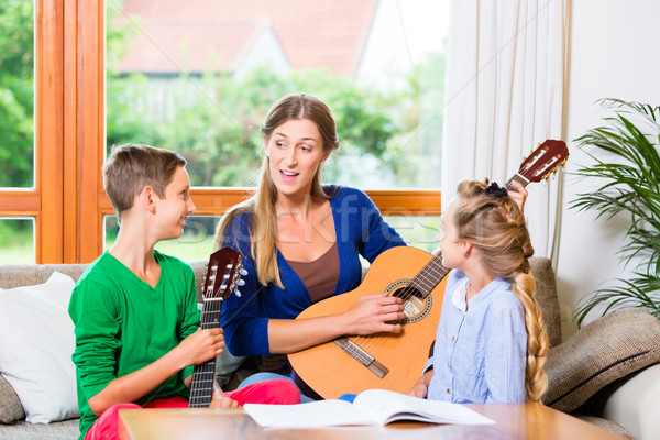 Family making music with guitar Stock photo © Kzenon