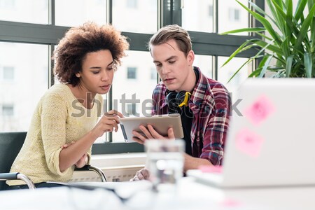 Cheerful woman writing an assignment while sitting between two c Stock photo © Kzenon