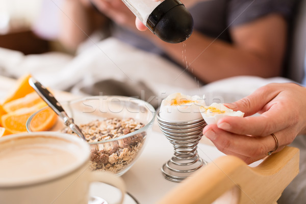 Close-up of salt shaker above soft boiled egg Stock photo © Kzenon