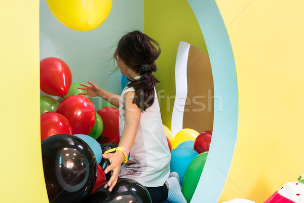 Cute girl playing with colorful balloons during playtime at the kindergarten Stock photo © Kzenon