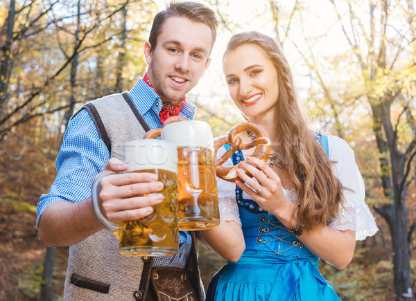 Woman and man in Bavarian Tracht drinking beer Stock photo © Kzenon