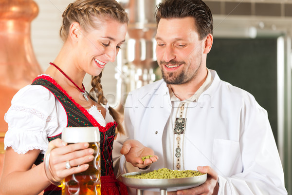 brewer and woman with beer glass in brewery Stock photo © Kzenon