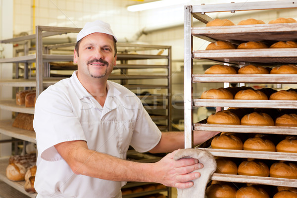 Baker in his bakery baking bread Stock photo © Kzenon