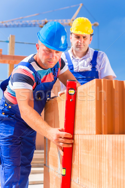 Budowa pracowników budynku powłoki murarz kaski Zdjęcia stock © Kzenon