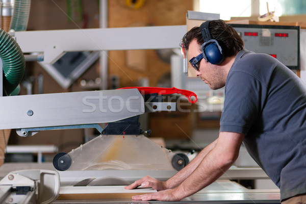 Carpenter using electric saw Stock photo © Kzenon