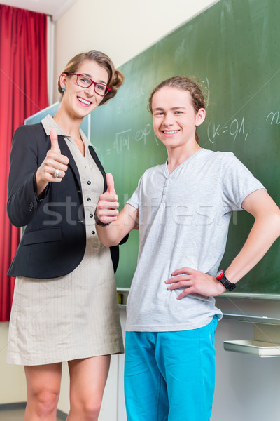 Teacher motivating students in school class Stock photo © Kzenon