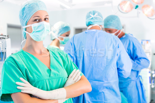 Surgeons operating patient in operation theater Stock photo © Kzenon