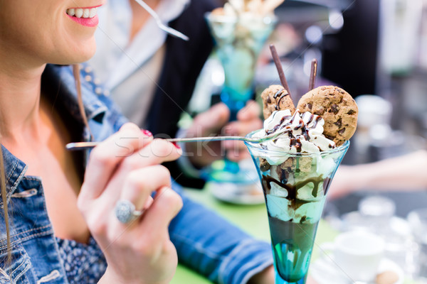 Couple enjoying an ice cream sundae in cafe Stock photo © Kzenon