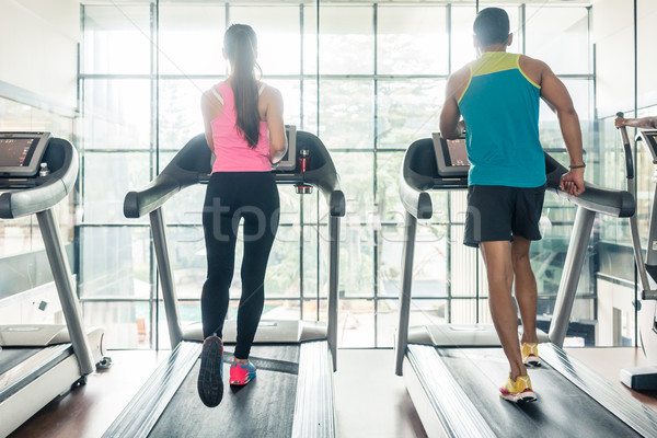 Rear view of a fit woman and her cardio workout partner running  Stock photo © Kzenon