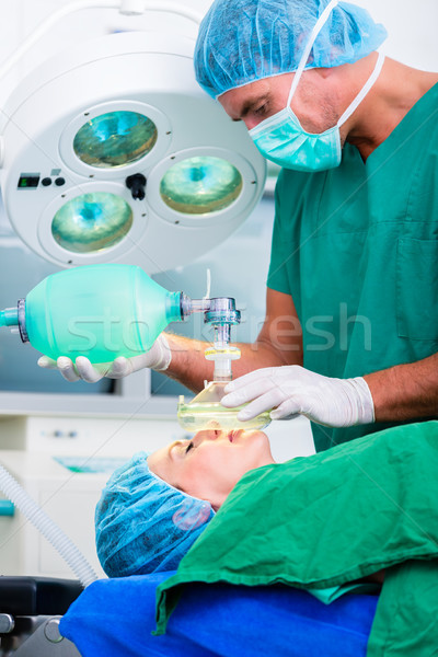 Doctor surgeon with patient in operating room Stock photo © Kzenon