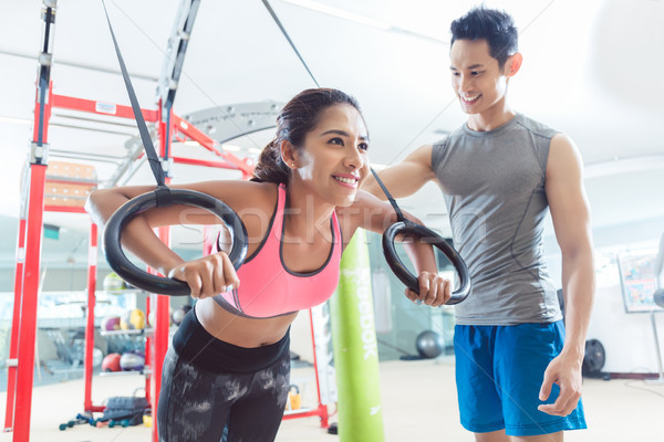 [[stock_photo]]: Belle · jeune · femme · souriant · gymnastique · anneaux